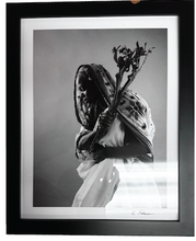 Load image into Gallery viewer, Framed black and white photograph of a person holding a flower
